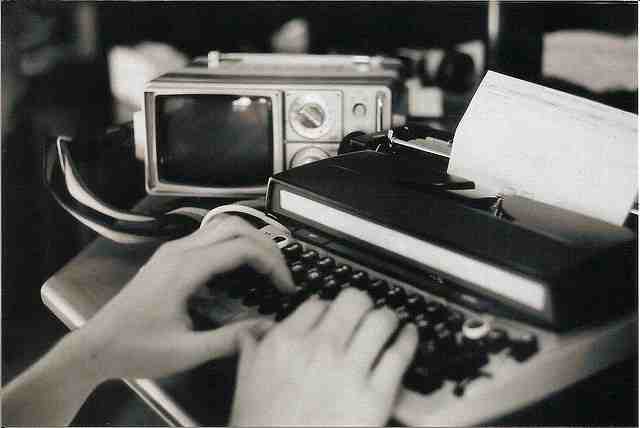 A persons hands on
a typewriter keyboard
