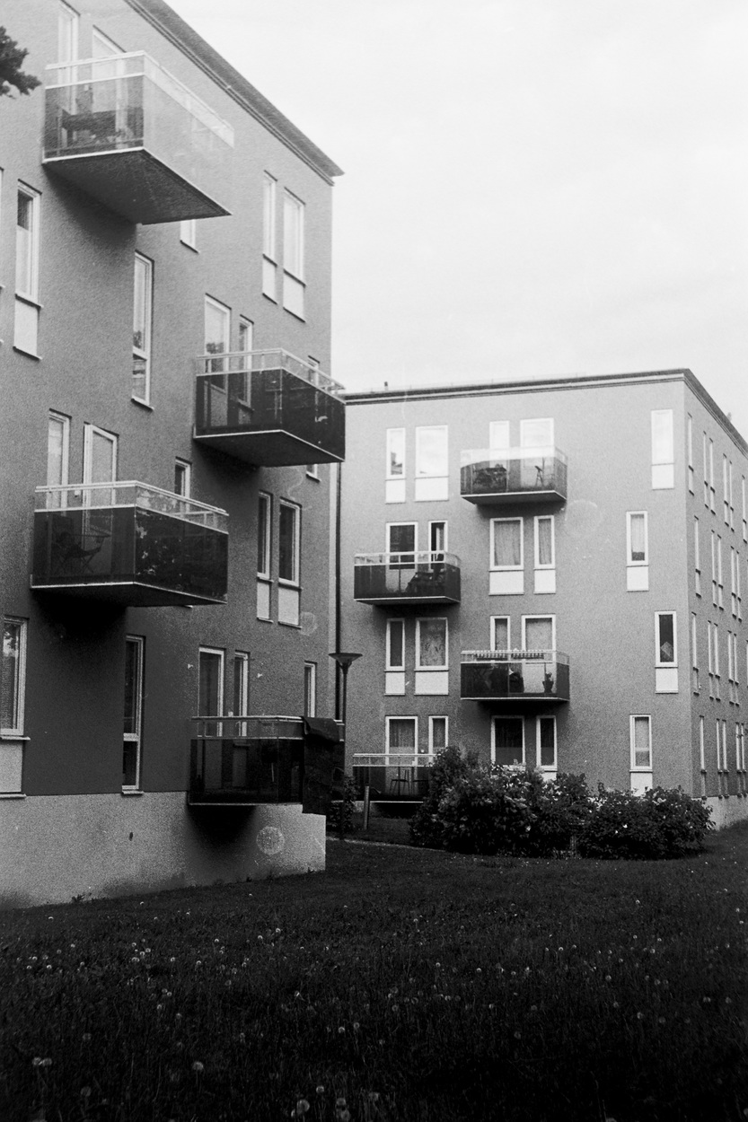 A photo of two very regular concrete buildings with pronounced balconies